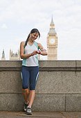 UK, London, Woman in sportswear with Big Ben behind