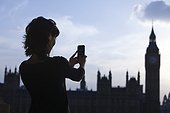 UK, London, Mid adult woman taking picture of Big Ben