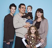 Portrait of family with three children (16-17, 8-9, 2-3), studio shot