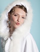Portrait of happy bride wearing fur hood and puckering lips