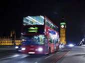 UK, London, Double decker bus driving at night
