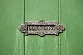 UK, London, Old fashion mail slot on wooden green doors
