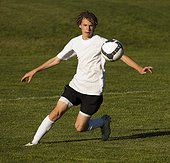 USA, Utah, Orem, teenage (14-15) boy playing soccer