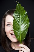 Young woman holding leaf