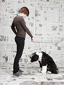 Young woman scolding her portuguese water dog