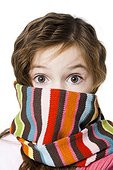 Girl (6-7) wrapped with striped scarf,studio shot