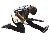 Studio shot of young man (18-19) jumping in air while playing guitar