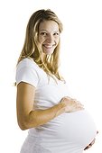 Studio shot of a pregnant young woman holding her belly