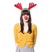 Studio shot of young woman wearing antlers and nose