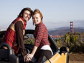 USA,California,San Francisco,Young couple in convertible car,with Golden Gate Bridge in background