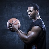 Portrait of male basketball player holding ball
