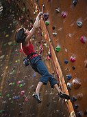 USA,Utah,Sandy,Female rockclimber on indoor climbing wall