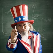Portrait of Uncle Sam holding chalk stick in classroom