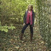 Portrait of a mature woman standing in a forest and smiling