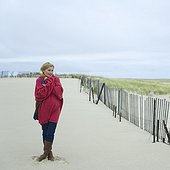 Mature woman standing on the beach