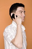 Side profile of a male office worker talking on a mobile phone