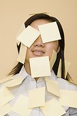 Close-up of a businesswoman covered with adhesive notes
