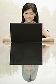 Female office worker using a laptop