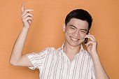 Male office worker talking on a mobile phone and smiling