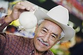 Portrait of a senior man holding an onion