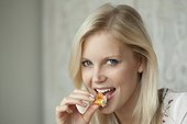 Young woman eating a croissant