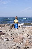 Little girl standing at the ocean