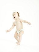 Standing female baby in diapers