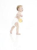 Standing male baby in diapers