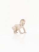 Crawling male baby in diapers