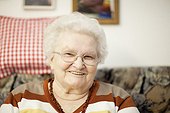 Smiling old woman with glasses, portrait