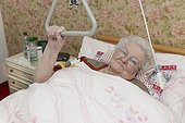 Old woman lying in sickbed, portrait