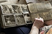 Old woman looking into photo album, close-up