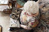 Old woman looking into photo album