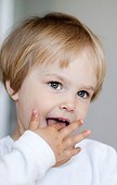 Little blond girl with finger in mouth