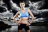 An athletic woman poses while running with a blue sports bra and black running shorts in front of Horsetooth Reservoir. Composite.