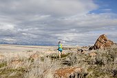 A woman out for an afternoon trail run on Antelope Island, Utah.