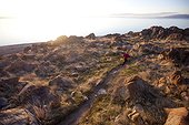 A woman out for an afternoon trail run on Antelope Island, Utah.