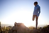 A woman stretching before an early morning run on the Wasatch Crest Trail.