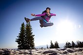 A woman jumping for joy on the Wasatch Crest trail.