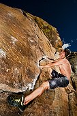 Rock climber climbing the Prow at Rotary Park adjacent to Horsetooth Reservoir in Fort Collins, Colorado, USA
