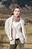 A young woman poses in layered outdoor clothing in Fort Collins, Colorado.