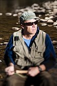 A man about to fly fish on the banks of the Poudre River, near Picnic Rock.