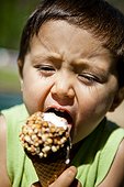 A young boy eats an ice cream cone at a roadside general store in the mountains of Colorado.
