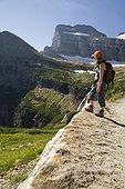 A woman in her early thirties hikes along the Grinnell Glacier trail in Glacier National Park, Montana.