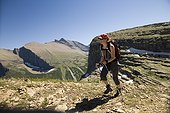 A woman in her early thirties hikes along the Grinnell Glacier trail in Glacier National Park, Montana.