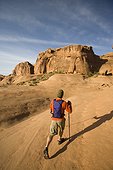 Young man hiking in Arches National Park near Moab, Utah.