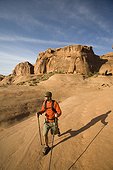 Young man hiking in Arches National Park near Moab, Utah.