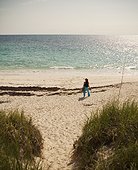 A woman on a beach, Elbow Cay, Hopetown, Bahamas