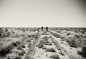 Two tourists stand in the desert near Cuba New Mexico