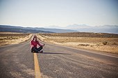 A young woman on a lonely road near La Sal, Utah.